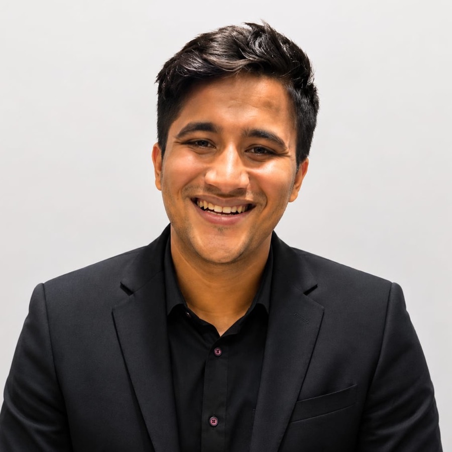Portrait of Krishan Harwani in a black suit, smiling.